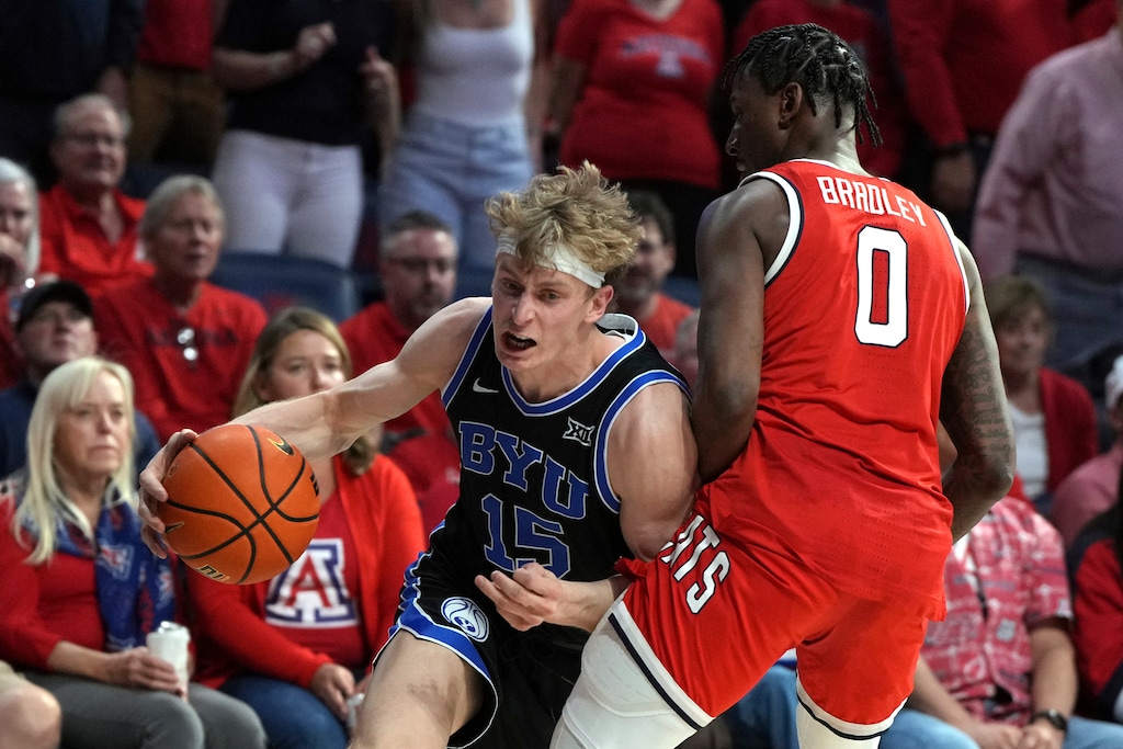 (Rick Scuteri | AP) BYU forward Richie Saunders (15) drives against Arizona guard Jaden Bradley (0) during the first half of an NCAA college basketball game, Saturday, Feb. 22, 2025, in Tucson, Ariz.