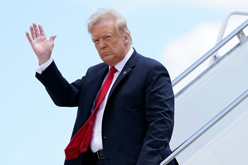FILE - In this Thursday, June 25, 2020, file photo, President Donald Trump waves as he arrives on Air Force One at Austin Straubel International Airport in Green Bay, Wis. Trump seems to rarely leave a thought unspoken. Of late, though, it is increasingly clear there are things Trump won’t say, and they are tied to the most important issues of his presidency. (AP Photo/Evan Vucci, File)