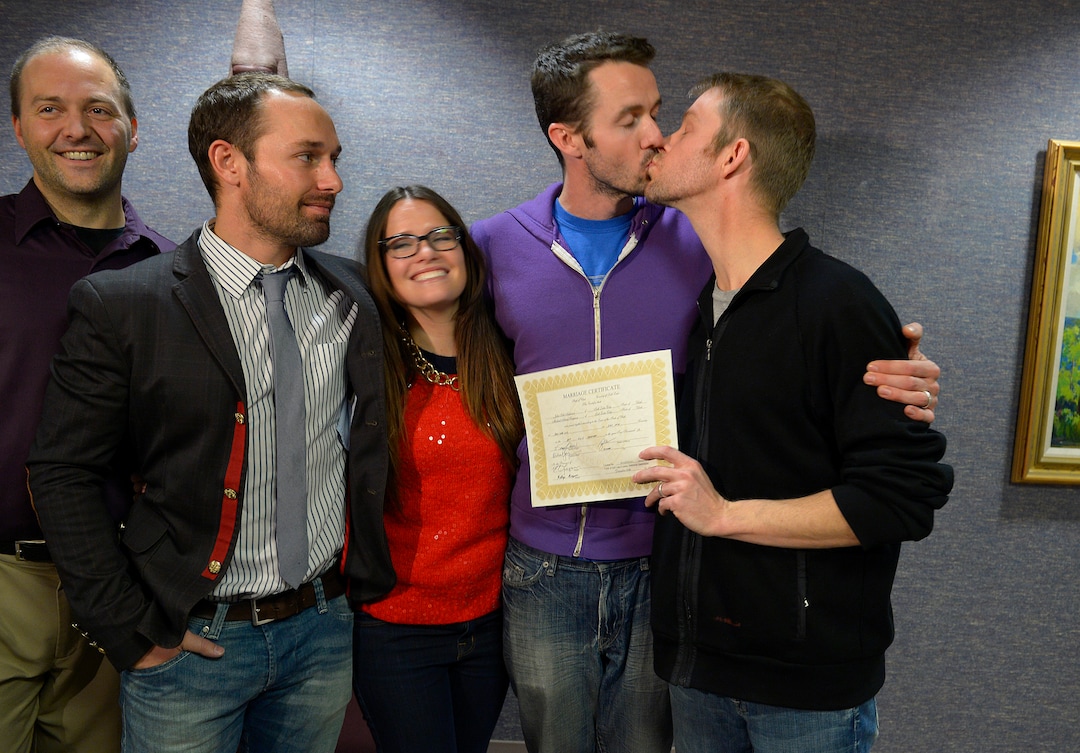 Scott Sommerdorf   |  The Salt Lake TribuneMichael Ferguson leans in to kiss his husband Seth Anderson, right, after they were married at the Salt Lake County offices, Friday December 20, 2013. With them are friends Jeff Anderson, left, Blake Ferguson, and Danielle Morgan. Michael Ferguson and Seth Anderson, (holding their marriage certificate)  were the first couple to be married under the now legal same sex marriage decision handed down by a federal judge just minutes before their ceremony.