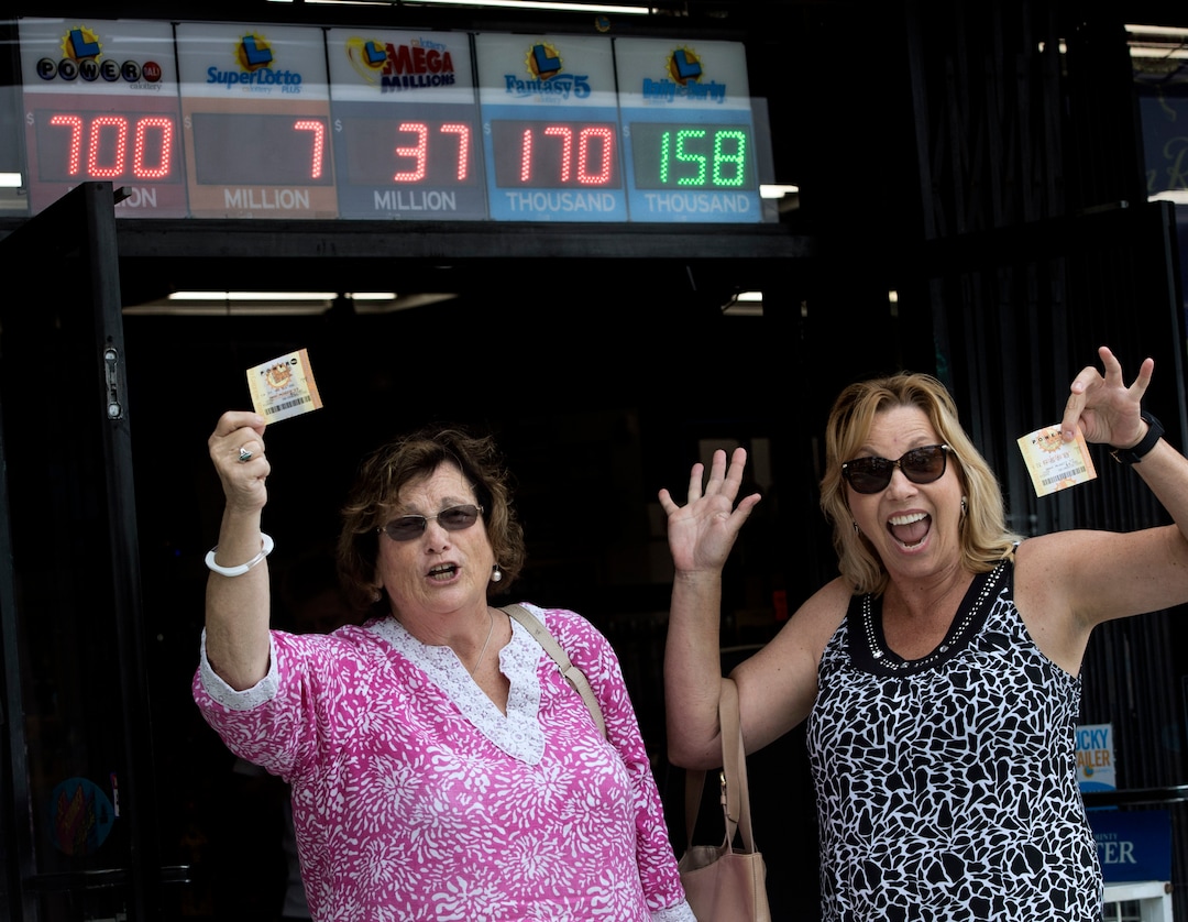 Sharon Sutton, left, and Noreen Mason leave a liquor store in Costa Mesa, Calif., Wednesday, Aug. 23, 2017, with their Powerball tickets and a dream of winning the $700 million jackpot. Sutton, who had never bought a lottery ticket, says she will let her husband retire from their small RV business if she wins. Mason says she will share the loot with family and friends, buy houses and travel to Europe. (Mindy Schauer/The Orange County Register via AP)