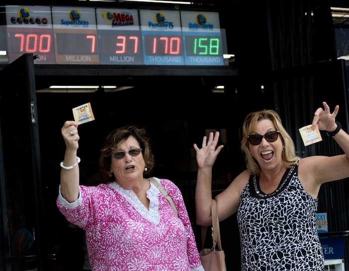 Sharon Sutton, left, and Noreen Mason leave a liquor store in Costa Mesa, Calif., Wednesday, Aug. 23, 2017, with their Powerball tickets and a dream of winning the $700 million jackpot. Sutton, who had never bought a lottery ticket, says she will let her husband retire from their small RV business if she wins. Mason says she will share the loot with family and friends, buy houses and travel to Europe. (Mindy Schauer/The Orange County Register via AP)