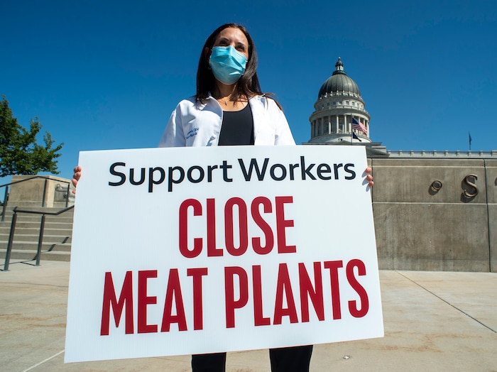 (Rick Egan | The Salt Lake Tribune) Certified Nurse-Midwife, Marti Nightingale holds a sign during protest at the State Capitol. Physicians Committee for Responsible Medicine is asking Gov. Herbert to close meatpacking plants in the state to slow the spread of the coronavirus, Thursday, July 30, 2020.