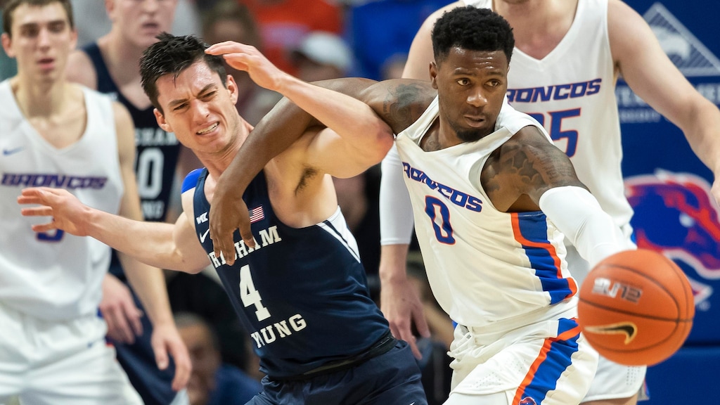 Boise State guard Marcus Dickinson and BYU guard Alex Barcello get tangled on a loose ball in the first half of an NCAA college basketball game Wednesday, Nov. 20, 2019, in Boise. (Darin Oswald/Idaho Statesman via AP)