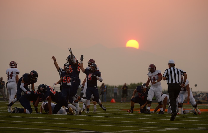(Leah Hogsten  |  The Salt Lake Tribune)  Brighton celebrates what they thought was a team interception. Brighton High School leads Herriman High School 9-7 at the half during the 2015 season opener at Brighton High School, Friday, August 21, 2015. 