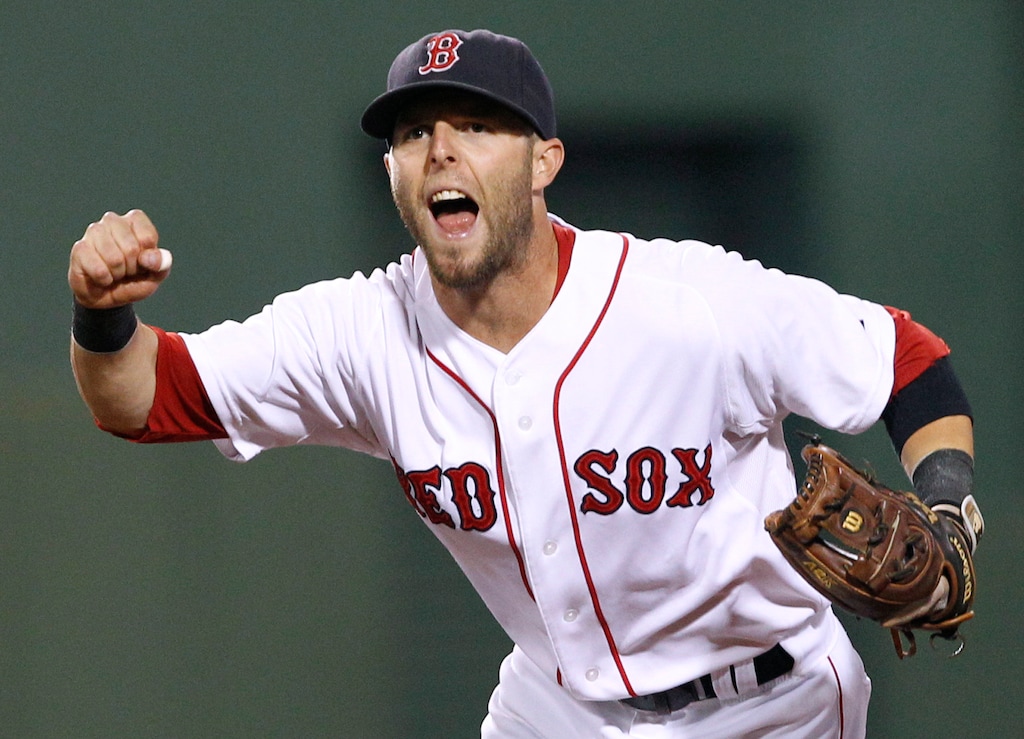 FILE - In this Aug. 16, 2011, file photo, Boston Red Sox second baseman Dustin Pedroia celebrates the completion of a triple play against the Tampa Bay Rays during the fourth inning of the second baseball game of a doubleheader in Boston. Pedroia, who was the 2007 Rookie of the Year and the AL MVP in his second season, retired Monday, Feb. 1, 2021. (AP Photo/Elise Amendola, File)