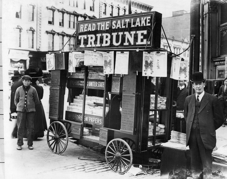 Salt Lake Tribune - Historical File WWII Surrender PageTwo persons are standing near The Salt Lake Tribune newspapers stall.