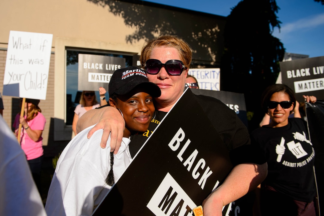 (Trent Nelson  |  The Salt Lake Tribune)Sophia Beecher is embraced by her mother Susan after speaking at a protest organized by Black Lives Matter and other groups at the Woods Cross Police Department on Friday June 14, 2019. The rally was to show support for DJ Hrubes, a 10-year-old black child who was held at gunpoint by a police officer last week while playing in his grandmother's front yard.