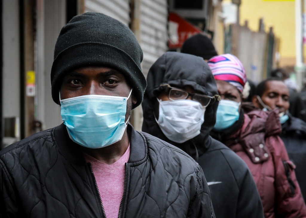 (Bebeto Matthews | AP photo) People wait for a distribution of masks and food from the Rev. Al Sharpton in the Harlem neighborhood of New York, after a new state mandate was issued requiring residents to wear face coverings in public due to the COVID-19 coronavirus, Saturday, April 18, 2020. "Inner-city residents must follow this mandate to ensure public health and safety," said Sharpton. The latest Associated Press analysis of available data shows that nearly one-third of those who have died from the coronavirus are African American, even though blacks are only about 14% of the population.