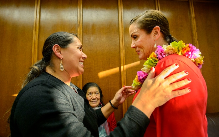 (Steve Griffin | The Salt Lake Tribune) Ofa Kaufusi places a fresh flower lei on the shoulders of her sister-in-law, Michelle Kaufusi, prior to Michelle being sworn into office as the first female mayor in Provo city's history. The small private ceremony was held in the Mayor's Office in Provo Tuesday January 2, 2018. A public Inauguration Ceremony for Mayor Kaufusi will be held at the Provo Library on January 18, 2018.