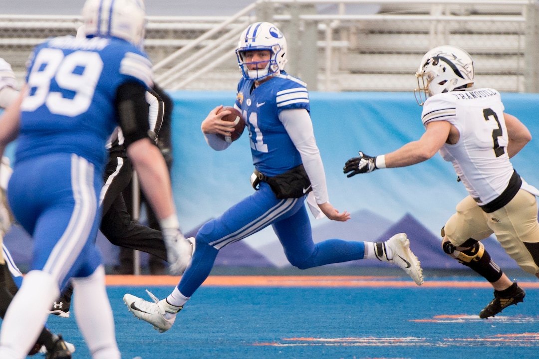 (Jeremy Harmon  |  The Salt Lake Tribune) Brigham Young Cougars quarterback Zach Wilson (11) runs the ball as BYU faces the Western Michigan Broncos in the Famous Idaho Potato Bowl in Boise, Idaho, on Friday, Dec. 21, 2018.