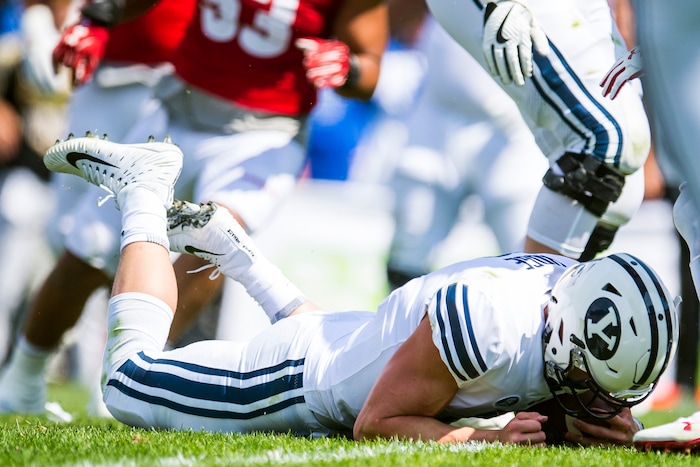 (Chris Detrick  |  The Salt Lake Tribune)   Brigham Young Cougars quarterback Beau Hoge (7) falls to the ground during the game at LaVell Edwards Stadium Saturday Saturday, September 16, 2017. Wisconsin Badgers are leading Brigham Young Cougars 24-6 at halftime.