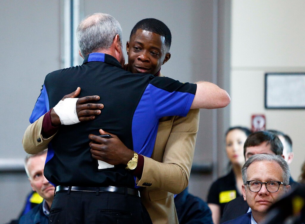 (Wade Payne/The Tennessean via AP) James Shaw, right, gets a hug from Waffle House CEO Walt Ehmer during a press conference on the Waffle House shooting Sunday, April 22, 2018 in Nashville, Tenn. Shaw wrestled the gun from the suspect.