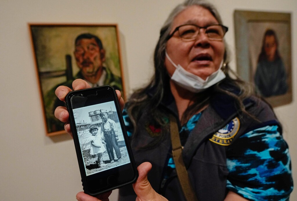 (Francisco Kjolseth | The Salt Lake Tribune) Lisa Hernandez pulls up a photo of her mom and uncle Kumiko and Minoru Akiyoshi during their time in the Topaz internment camp as she visits a new exhibit at the Utah Museum of Fine Arts entitled Pictures of Belonging, an exhibition produced by the Japanese American National Museum of Los Angeles, Friday, May 3, 2024.