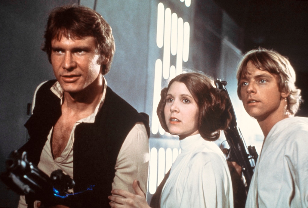 This publicity film image provided by 20th Century-Fox Film Corporation shows, from left, Harrison Ford as Han Solo, Carrie Fisher as Princess Leia Organa and Mark Hamill as Luke Skywalker in a scene from the "Star Wars" movie released by 20th Century-Fox in 1977. The classic Star Wars film that launched a science fiction empire is being dubbed in the Navajo language, with casting calls scheduled Monday, April 29, 2013, in Burbank, Calif., and on May 3 and 4 at the Navajo Nation Museum in Window Rock. Potential actors don't have to sound exactly like Princess Leia, Luke Skywalker or Han Solo, but should be able to deliver the lines with character. (AP Photo/20th Century-Fox Film Corporation)