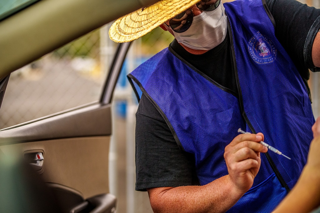 (Trent Nelson  |  The Salt Lake Tribune) Spencer Lowe administers a dose of the Pfizer COVID-19 vaccine at a drive-thru event organized by the Utah County Health Department in Spanish Fork on Friday, Sept. 10, 2021.
