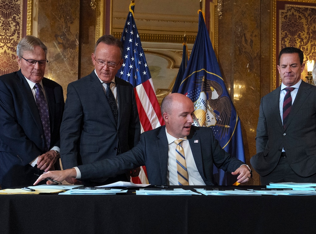 (Leah Hogsten | The Salt Lake Tribune) Gov. Spencer Cox is joined by from left, Sen. Jerry Stevenson, R-Layton, Senate President Stuart Adams, R-Layton and House Speaker Brad Wilson, R-Kaysville for the ceremonial signing of 6 bills in the Capitol Gold Room, Mar. 22, 2023.