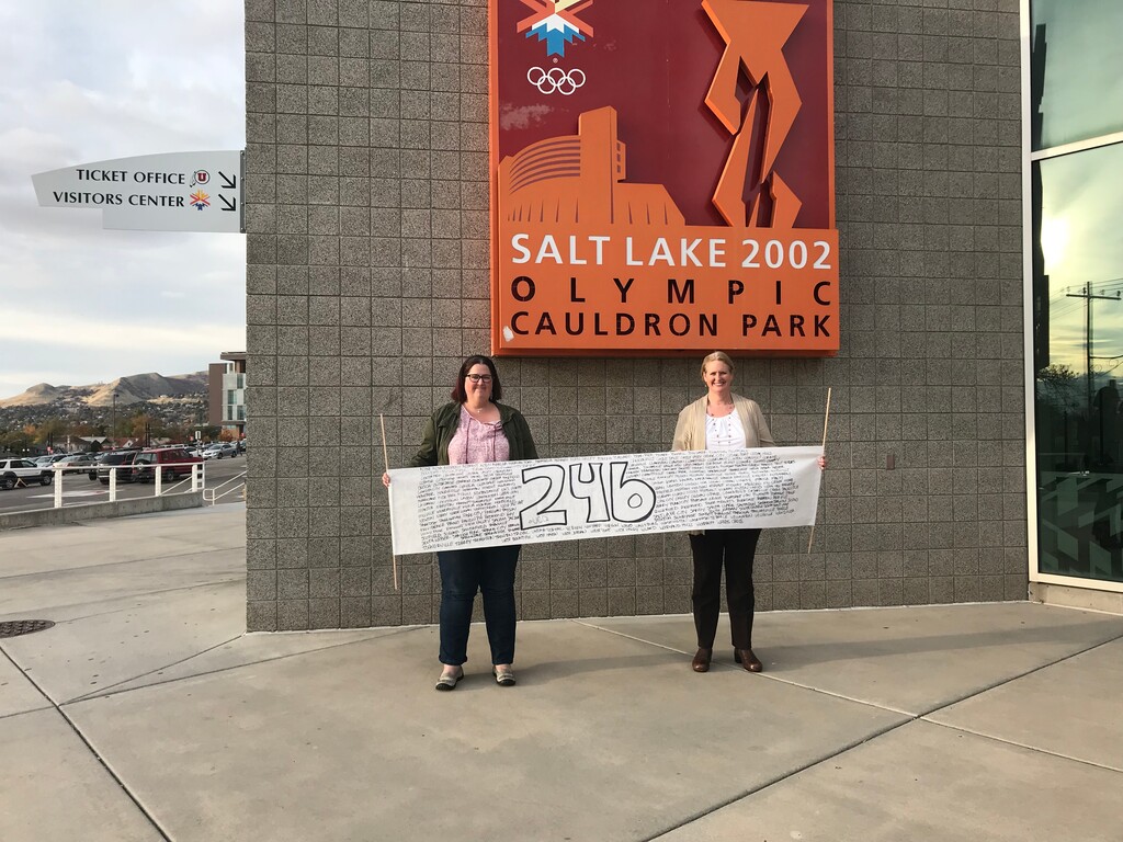 (Kim Woodbury) Kim Petersen, left, and Kim Woodbury hold a sign displaying the names of all 246 Utah cities they visited between May 2016 and October 2018. Salt Lake City was their final stop.