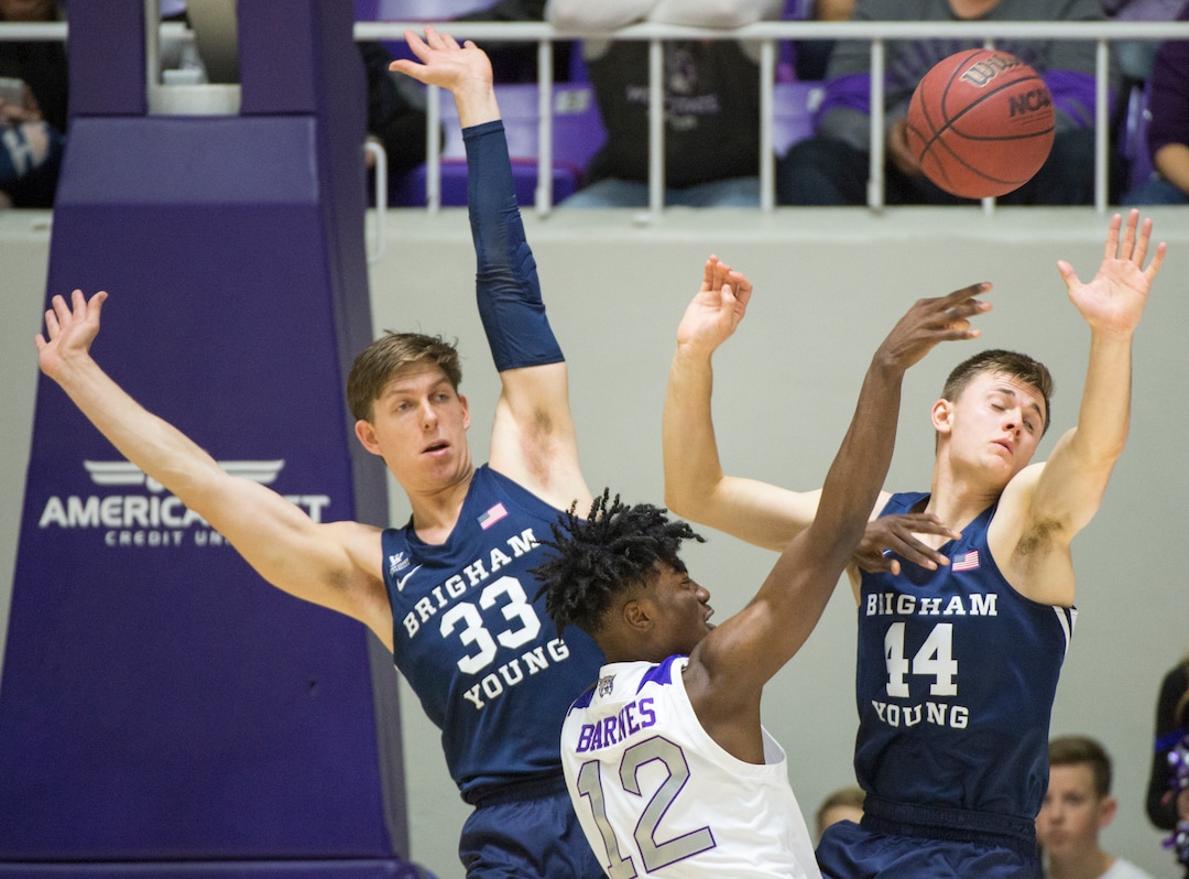 (Rick Egan  |  The Salt Lake Tribune)       Weber State Wildcats guard Israel Barnes (12) collides with Brigham Young Cougars forward Dalton Nixon (33) and Brigham Young Cougars guard Connor Harding (44), in basketball action between Brigham Young Cougars and Weber State Wildcats, at the Dee Event Center in Ogden, Saturday, Dec. 1, 2018.