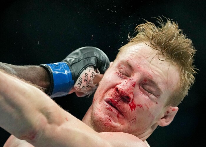 (Francisco Kjolseth | The Salt Lake Tribune) Aj Fletcher of the United States takes a hit from Ange Loose of Congo-Kinshasa in their welterweight bout at Vivint Arena for UFC 278 on Saturday, Aug. 20, 2022. 