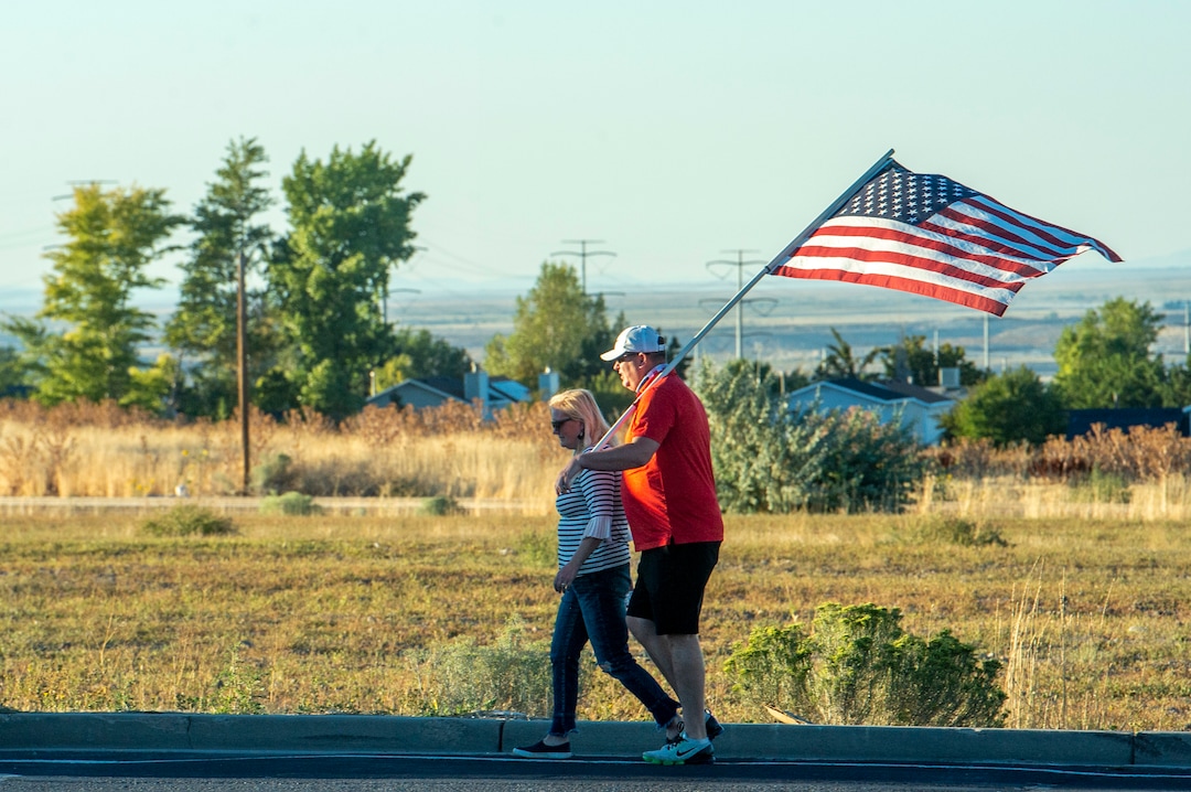 (Rick Egan  |  The Salt Lake Tribune)    A couple of police supporters walk back to their car with their flag, after the protest in West Valley City, on Thursday, Sept. 3, 2020.