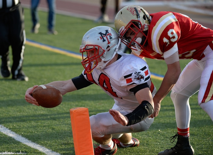 (Francisco Kjolseth  |  The Salt Lake Tribune)  Lance Fowles of Manti sets up his team for a touchdown as he's pressured by Alex Snarr of Judge in the Class 3A football playoff game on Thursday, Oct. 19, 2017. 