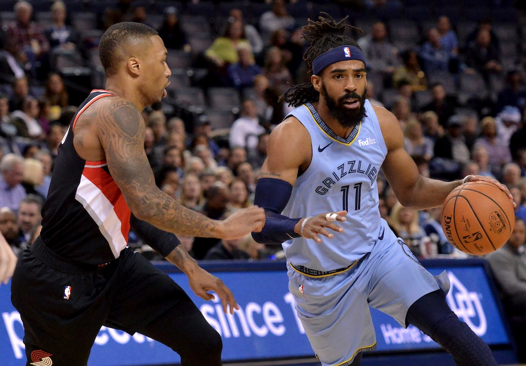 Memphis Grizzlies guard Mike Conley (11) drives against Portland Trail Blazers guard Damian Lillard in the first half of an NBA basketball game on Wednesday, Dec. 12, 2018, in Memphis, Tenn. (AP Photo/Brandon Dill)