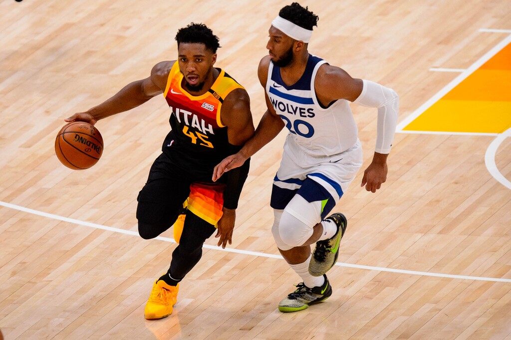 (Trent Nelson  |  The Salt Lake Tribune) Utah Jazz guard Donovan Mitchell (45) is defended by Minnesota Timberwolves guard Josh Okogie (20) as the Utah Jazz host the Minnesota Timberwolves in Salt Lake City on Saturday, Dec. 26, 2020.