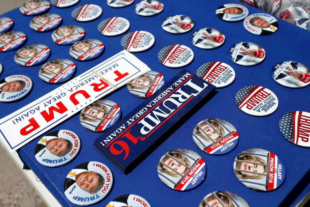 (Brennan Linsley | The Associated Press) Buttons and stickers for sale before a campaign event with Republican presidential candidate Donald Trump, at the Rimrock Auto Arena, in Billings, Mont., Thursday, May 26, 2016.