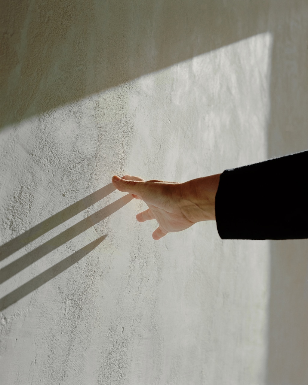 (Cedrine Scheidig | The New York Times)
The shadow from a hand is seen on a wall in Paris, Sept. 28, 2021. "This process of post-traumatic growth is more like rewriting a novel than like solving a problem or healing a wound," writes New York Times columnist David Brooks. "It's a process of reconsidering and reorganizing — crafting a different story."