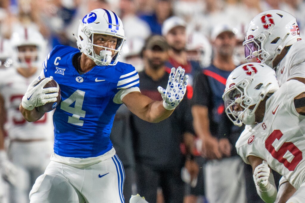 (Rick Egan | The Salt Lake Tribune) Brigham Young Cougars running back LJ Martin (4) runs for a huge gain as Stanford Cardinal cornerback Collin Wright (6) defends in football action between the Brigham Young Cougars and the Stanford Cardinal, at Lavell Edwards Stadium on Saturday Sept. 6, 2025.