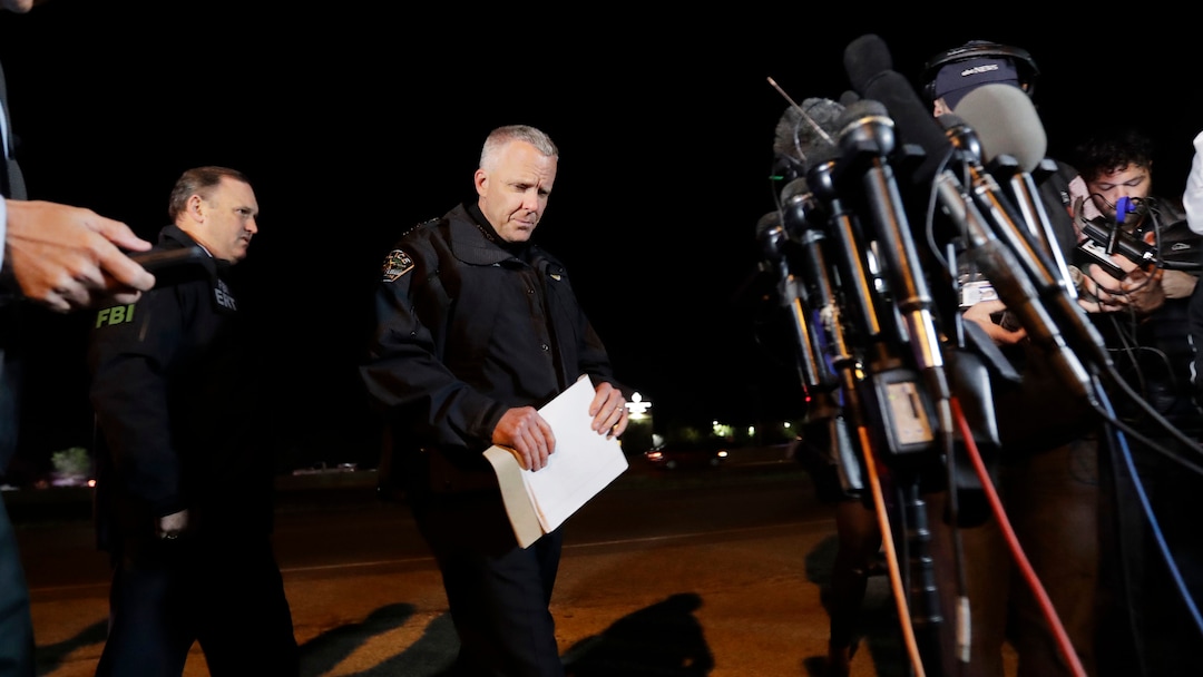 Austin Police Chief Brian Manley, right, prepares to brief the media, Wednesday, March 21, 2018, in the Austin suburb of Round Rock, Texas. The suspect in a spate of bombing attacks that have terrorized Austin over the past month blew himself up with an explosive device as authorities closed in, the police said early Wednesday. (AP Photo/Eric Gay)