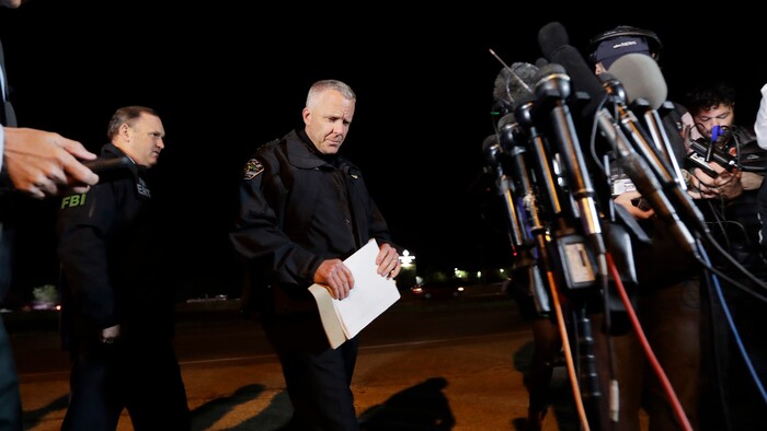 Austin Police Chief Brian Manley, right, prepares to brief the media, Wednesday, March 21, 2018, in the Austin suburb of Round Rock, Texas. The suspect in a spate of bombing attacks that have terrorized Austin over the past month blew himself up with an explosive device as authorities closed in, the police said early Wednesday. (AP Photo/Eric Gay)