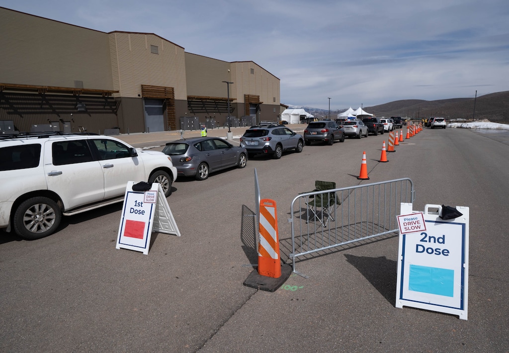 (Francisco Kjolseth | The Salt Lake Tribune) People line up for their COVID-19 vaccine on Thursday, March 18, 2021, as the Utah Film Studios in Park City loans its space to the Summit County Health Department as a drive-thru COVID-19 vaccination station.