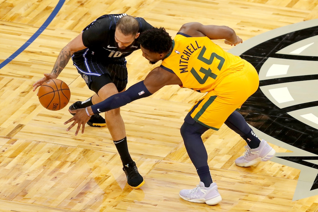 Orlando Magic guard Evan Fournier (10) keeps the ball from Utah Jazz guard Donovan Mitchell (45) in the first quarter during an NBA basketball game, Saturday, Feb. 27, 2021, in Orlando, Fla. (AP Photo/Joe Skipper)