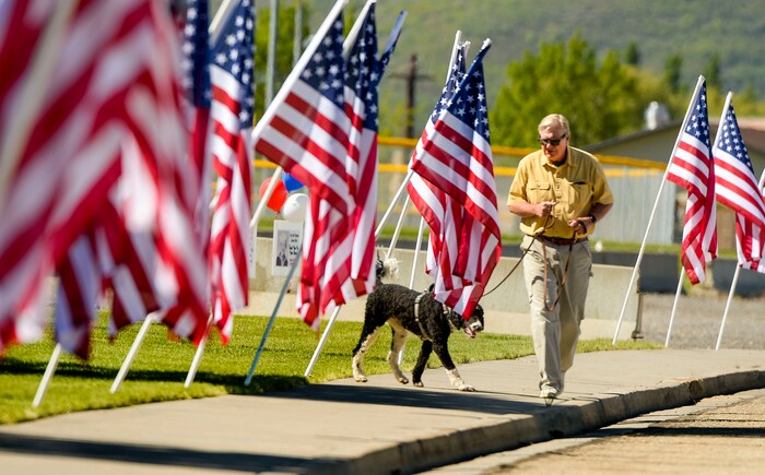 (Leah Hogsten  |  The Salt Lake Tribune) Mark Middleton and his dog Bernie walk through the Heber City 2020 Memorial Day Drive By Tribute to remember and honor all of our military, past and present, men and women who serve or have served in our Armed Forces, May 25, 2020.