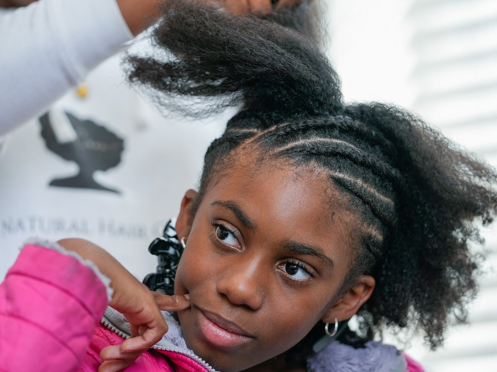 (Leah Hogsten | The Salt Lake Tribune) Lexy Heuston, 11, patiently sits in a salon chair for eight hours as Essence of Ebony hair salon owner and stylist Imani Powell braids her hair into cornrows, March 10, 2022, in West Jordan.