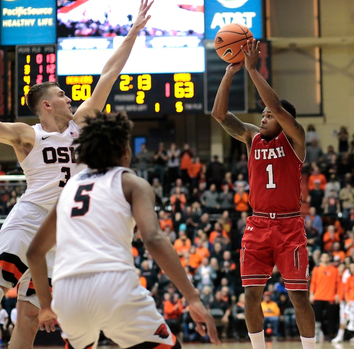 Utah's Justin Bibbins (1) shoots as Oregon State's Tres Tinkle (3) and Ethan Thompson (5) defend during the second half of an NCAA college basketball game in Corvallis, Ore., Sunday, Dec. 31, 2017. Utah won 66-64. (AP Photo/Timothy J. Gonzalez)
