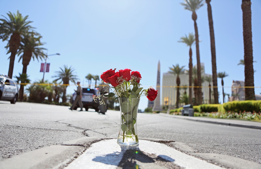 (Ronda Churchill  |  AP Photo)  A vase of roses is shown at the edge of a police barricade on the Las Vegas Strip Monday, Oct. 2, 2017, in Las Vegas. A mass shooting occurred late night Sunday at a music festival on the Las Vegas Strip.