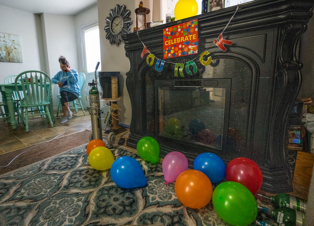 (Rick Egan | The Salt Lake Tribune) Tina stretches her oxygen cord into the kitchen, as she talks to her dad on the phone, at home at Idaho Falls, Idaho, on Thursday, Sept. 23, 2021. Lewis spent most of the past 6 months in hospitals sick with COVID-19.