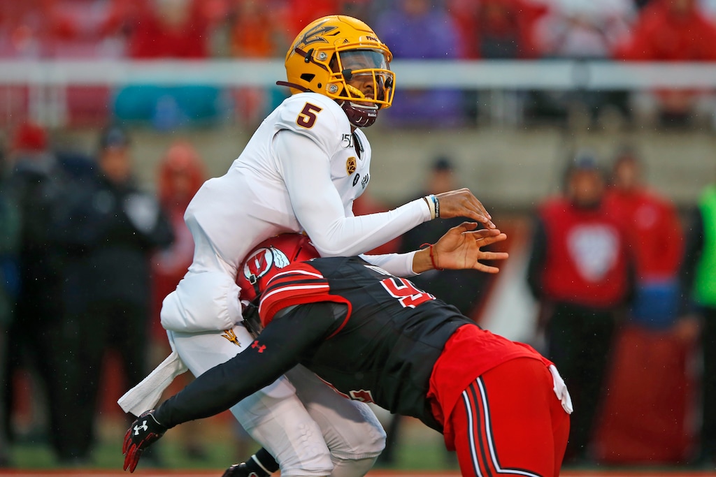 Arizona State quarterback Jayden Daniels (5) takes a hit from Utah defensive end Maxs Tupai (92) during the first half of an NCAA college football game Saturday, Oct. 19, 2019, in Salt Lake City. (AP Photo/Rick Bowmer)