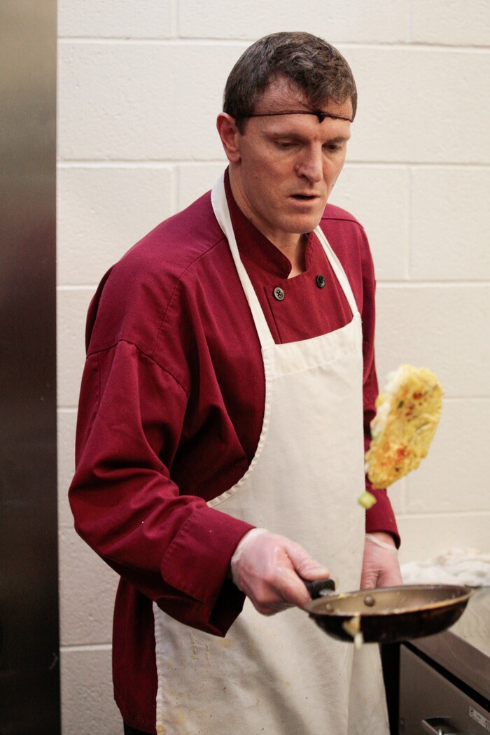 In this photo taken Jan. 26, 2018, Jesse Jorgenson flips an omelette at the Code 7 Cafe in the Utah County Jail in Spanish Fork, Utah. The Utah County Jail Culinary Arts program utilizes inmates labor in the commercial kitchen.(Evan Cobb/The Daily Herald via AP)
