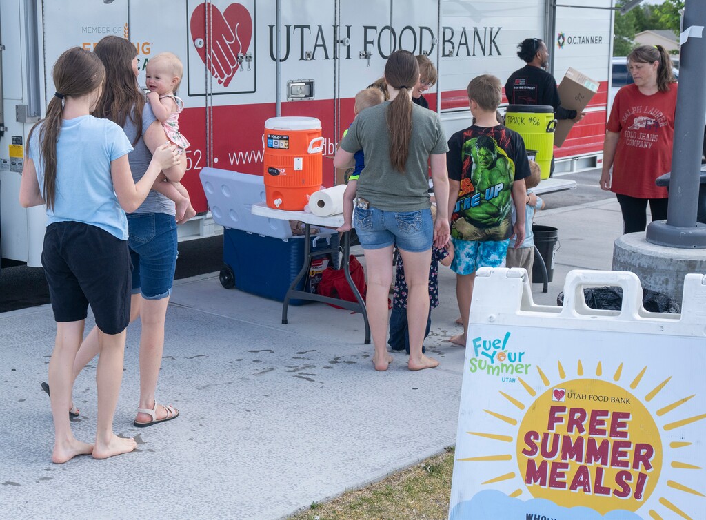 (Rick Egan | The Salt Lake Tribune)  Jessica Scott, mobile school pantry coordinator, for the Utah Food Bank, hands out sack lunches at the Magna Regional Park, on Friday, June 21, 2024.