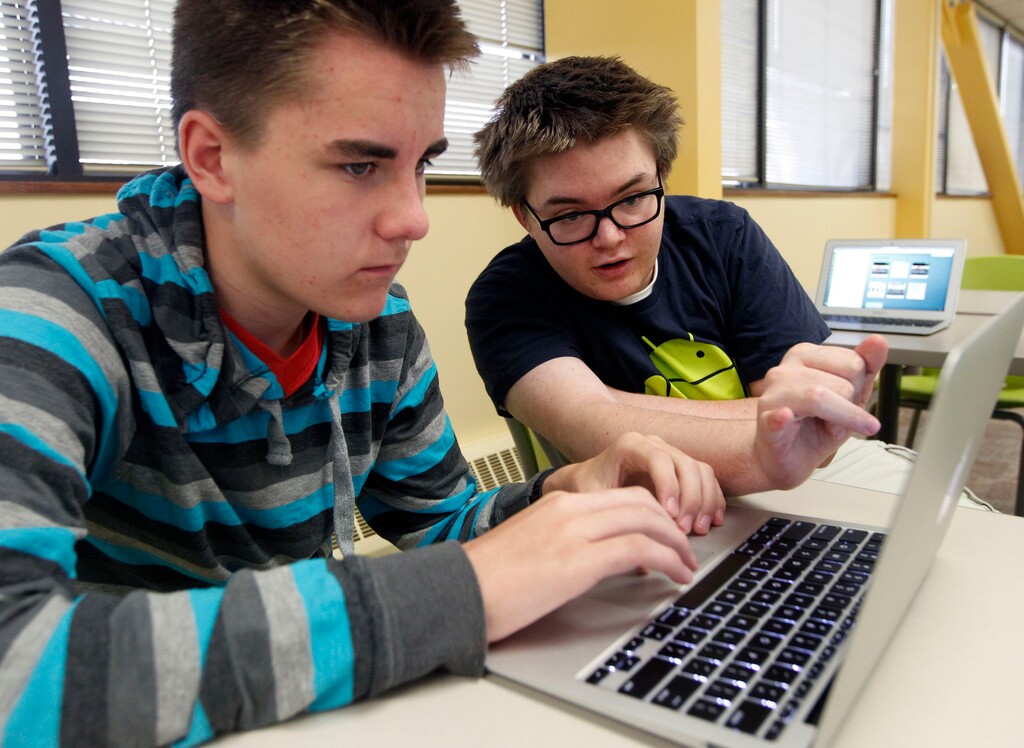 Al Hartmann | The Salt Lake Tribune
Tevis Hadley, left, sets up his face time and email accounts with some help from Arthur Tucker at Kaysville charter school Career Path High Tuesday September 10. Both are juniors at the school. All 175 students were assigned an Apple laptop for the school year.