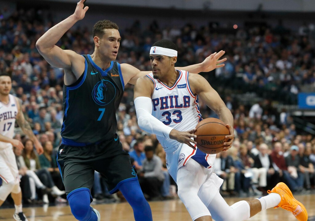 Philadelphia 76ers forward Tobias Harris (33) drives against Dallas Mavericks forward Dwight Powell (7) during the first half of an NBA basketball game in Dallas, Monday, April 1, 2019. (AP Photo/LM Otero)