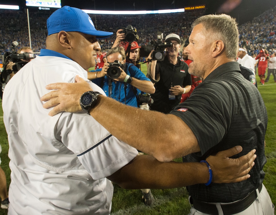 (Rick Egan  |  The Salt Lake Tribune)  Brigham Young Cougars head coach Kalani Satike hugs Utah head coach Kyle Whittingham after BYU was defeated by Utah, 19-13, at Lavell Edwards Stadium in Provo, Saturday, September 9, 2017.
