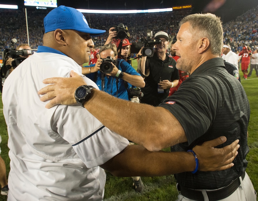 (Rick Egan  |  The Salt Lake Tribune)  Brigham Young Cougars head coach Kalani Satike hugs Utah head coach Kyle Whittingham after BYU was defeated by Utah, 19-13, at Lavell Edwards Stadium in Provo, Saturday, September 9, 2017.