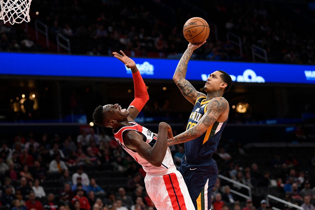 Utah Jazz guard Jordan Clarkson, right, fouls Washington Wizards guard Isaac Bonga, left, during the first half of an NBA basketball game, Sunday, Jan. 12, 2020, in Washington. (AP Photo/Nick Wass)
