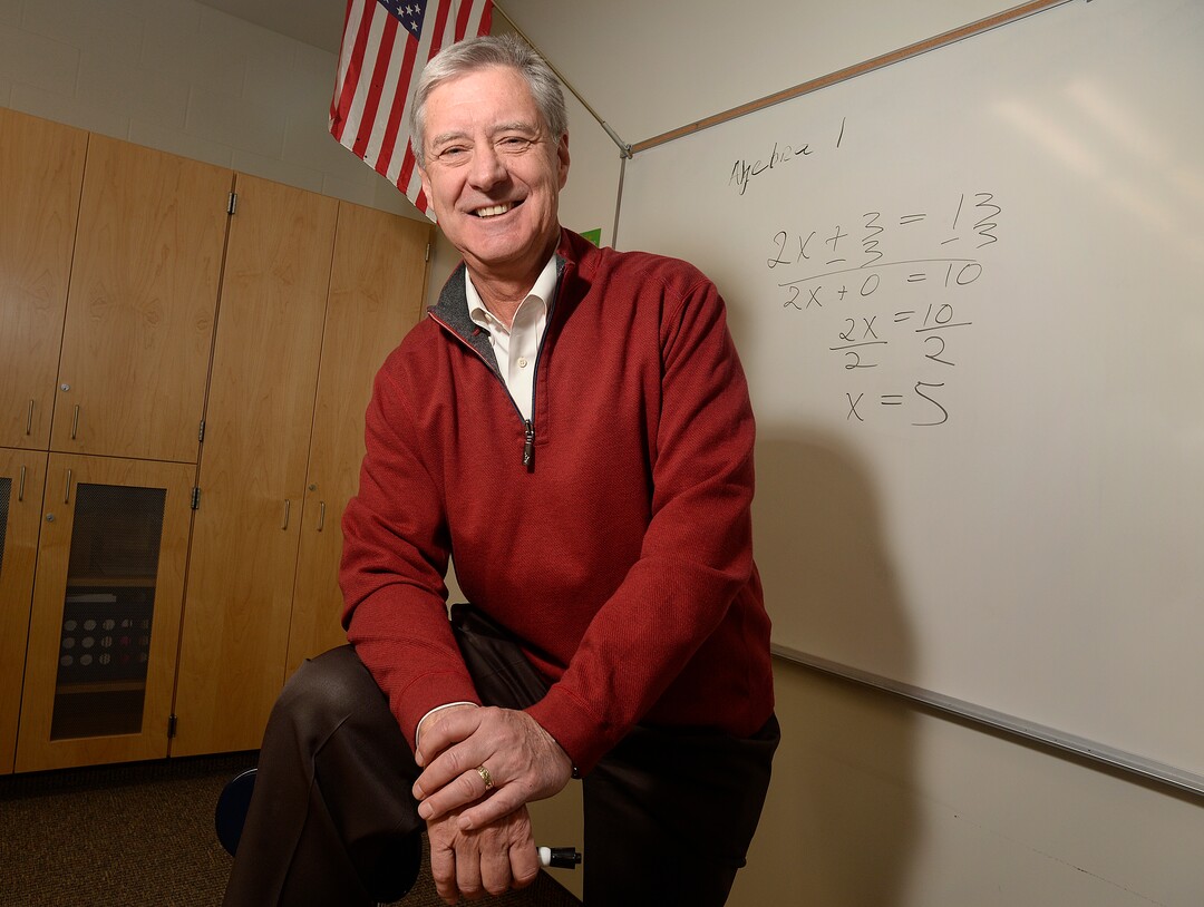 (Scott Sommerdorf   |  Tribune File Photo)  University of Utah athletic director Chris Hill poses in a math classroom, Thursday, February 9, 2017, with an equation like the ones he taught during his time there as a teacher. Early in his career, Hill spent four years at Granger High as a math teacher and basketball coach. 