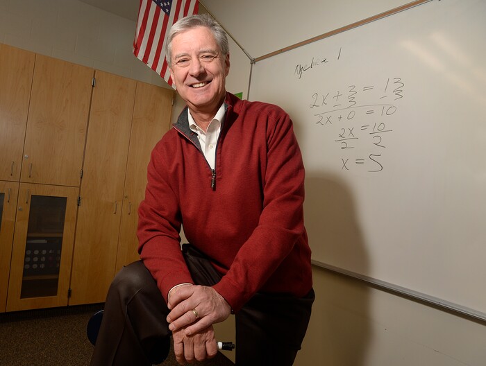 (Scott Sommerdorf   |  Tribune File Photo)  University of Utah athletic director Chris Hill poses in a math classroom, Thursday, February 9, 2017, with an equation like the ones he taught during his time there as a teacher. Early in his career, Hill spent four years at Granger High as a math teacher and basketball coach. 