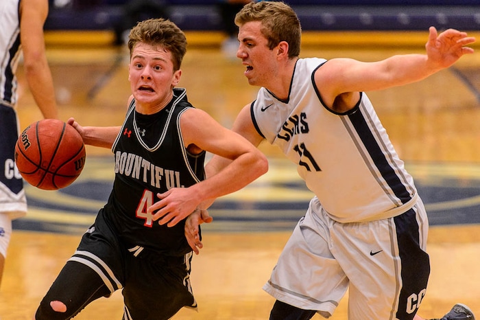(Trent Nelson | The Salt Lake Tribune)  Bountiful's David Stevenson (4) drives past Corner Canyon's Ammon Jensen (11) as Corner Canyon faces Bountiful in the title game of the Corner Canyon Tournament of Champions, high school boys' basketball in Draper, Saturday December 2, 2017.